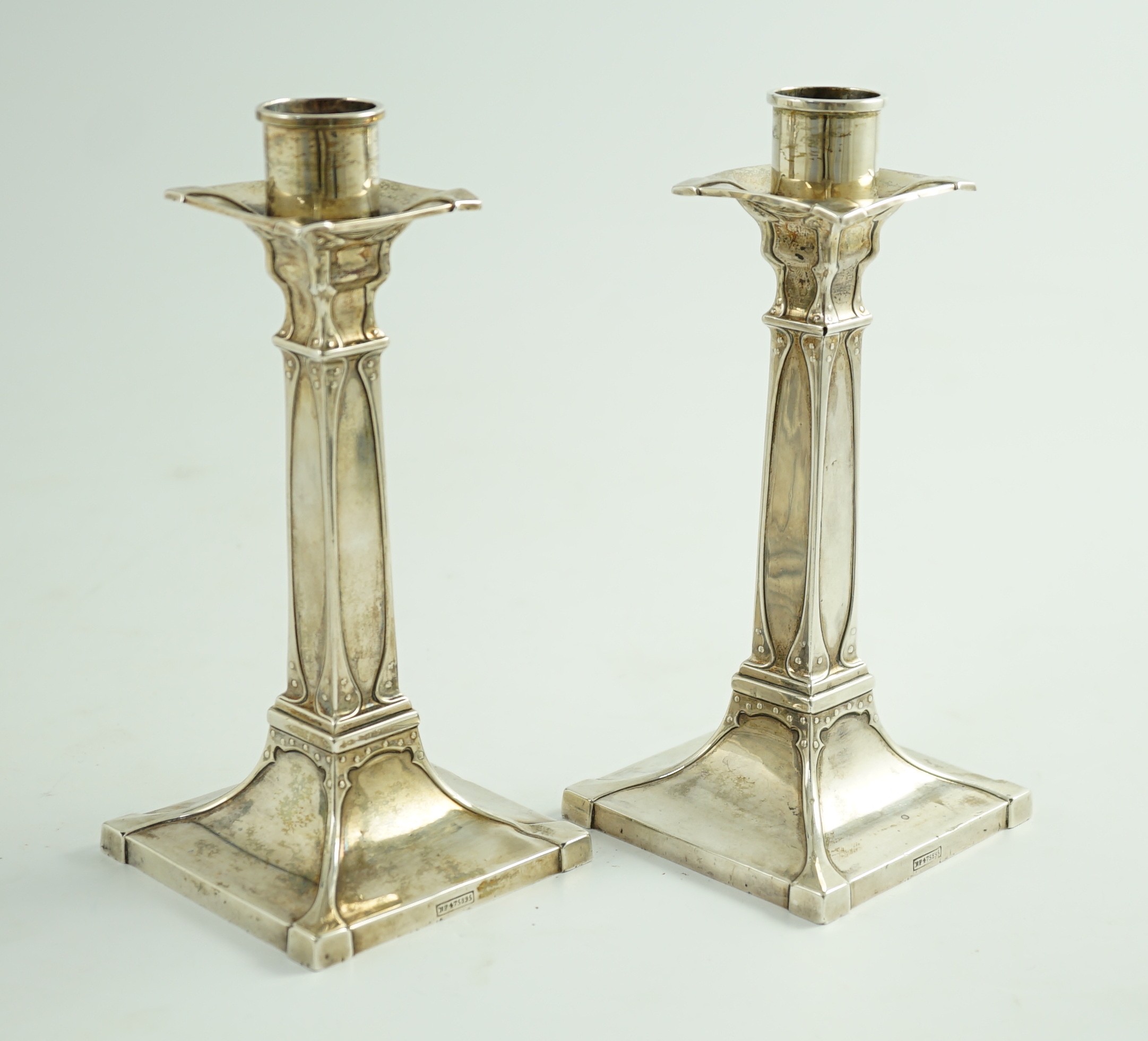 A pair of George V Arts & Crafts silver candlesticks, by William Hutton & Sons